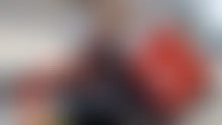 Man posing for a picture with a sign that says '1st'