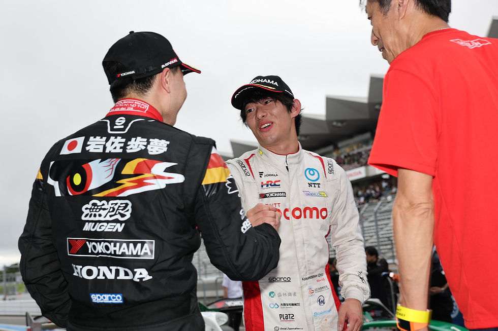 Credit: Super Formula | Ohta (centre) being congratulated by Iwasa (left) and team boss Muraoka (right)
