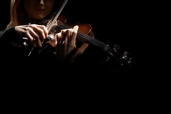 Violin player violinist hands. Musical instruments orchestra music playing violin closeup.