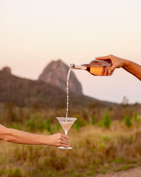 Pouring champagne in countryside