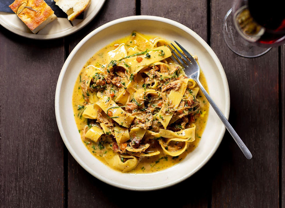 Creamy pappardelle pasta with herbs and bread.