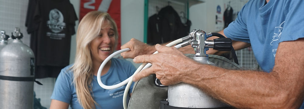 Instructor and student preparing gear for PADI course