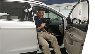 Placing a Glove Box Bible (Owners Manual For Life) in a glovebox at a Ford Dealership.
