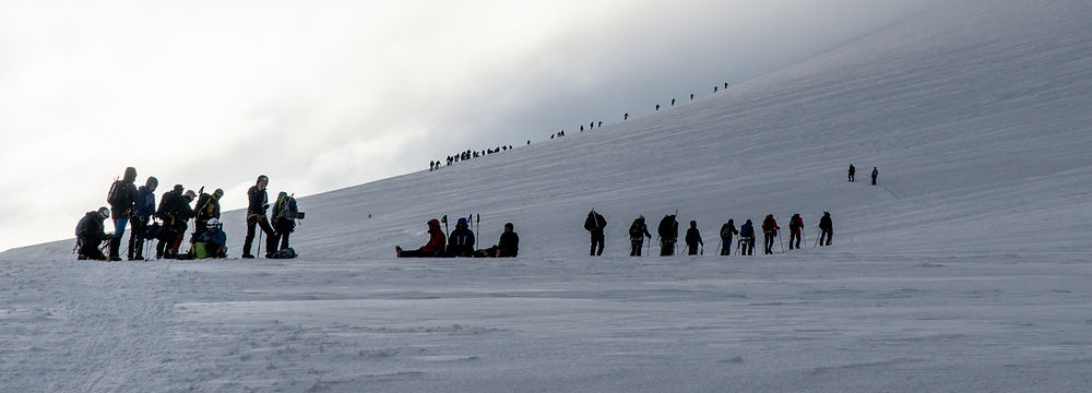 Group of mountaineers crossing a snowy glacier on Mount Kazbek