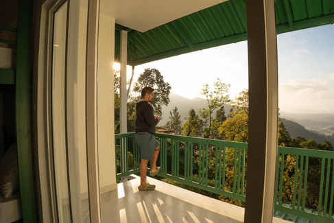 a backpacker relaxing on the balcony overlooking nature