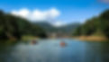 Eye-level view of Mattupetty Dam with serene waters and surrounding trees