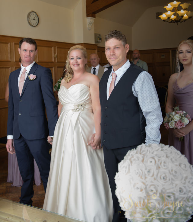 a bride and groom are posing for a picture with their wedding party