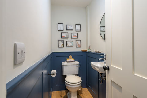 Cloakroom with bespoke wall panelling.