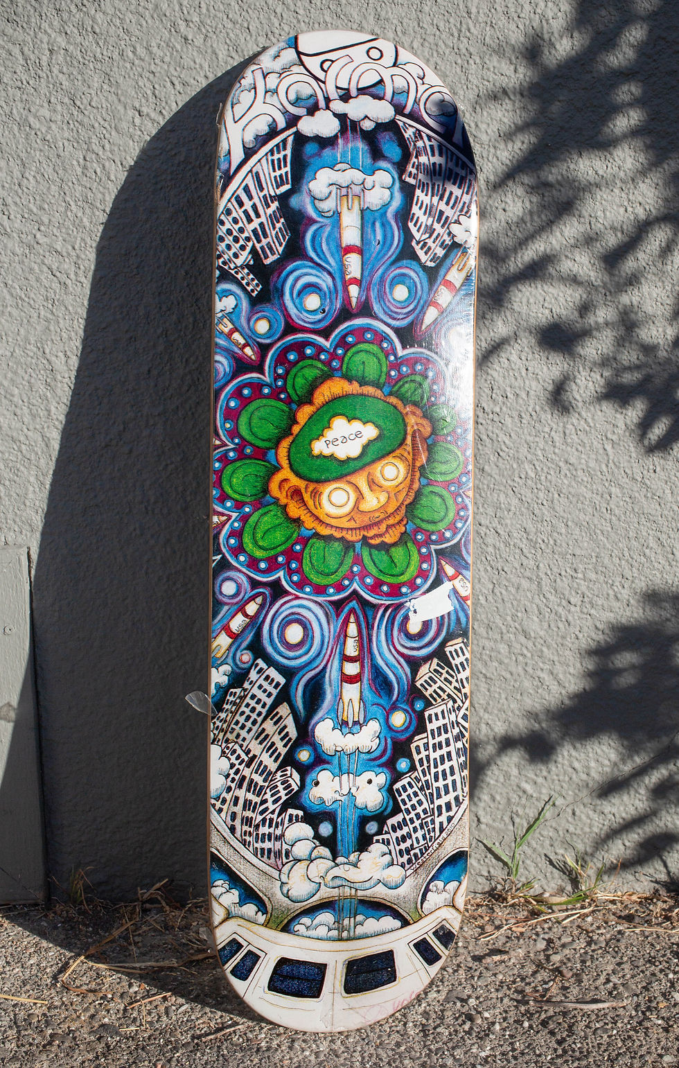 surrealist pop punk art on the bottom of a skateboard deck by Kip Westerfield