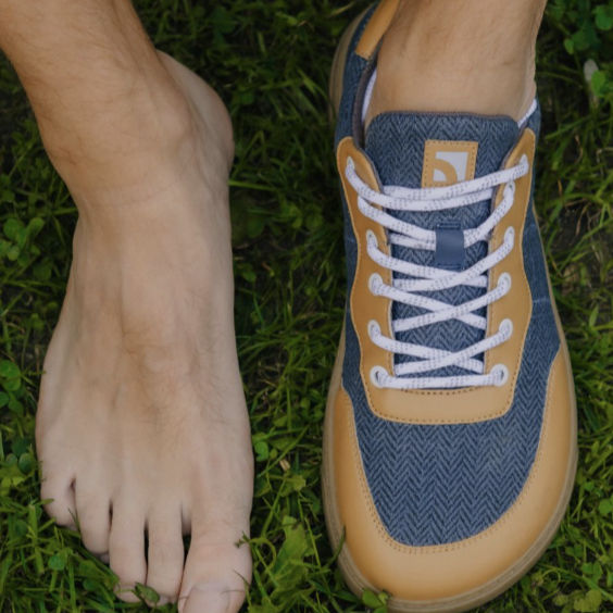 two feet one without a shoe on and one with a shoe on
