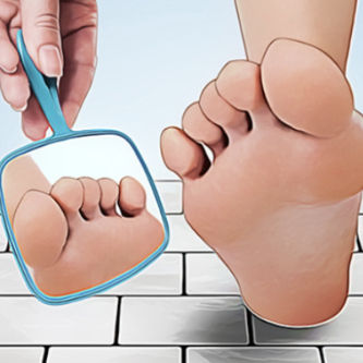 a foot next to a hand holding a mirror with the reflection of the bottom of the foot in it