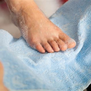 a foot with soap on it in a towel