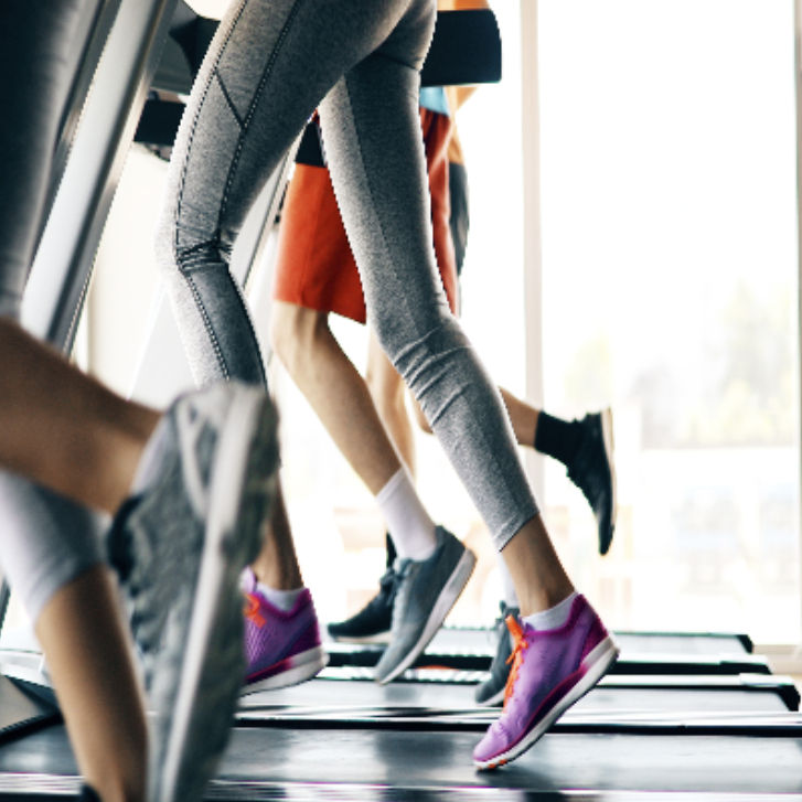 people running on treadmills showing their waist down
