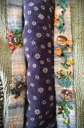 adorable stitching on sweater needin fixin.jpg