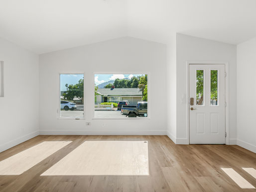 refinished living room with open windows and wood floors