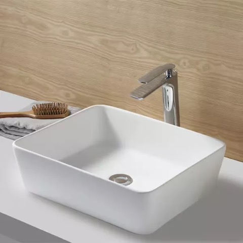 Floating white sink on grey countertops with silver finishes