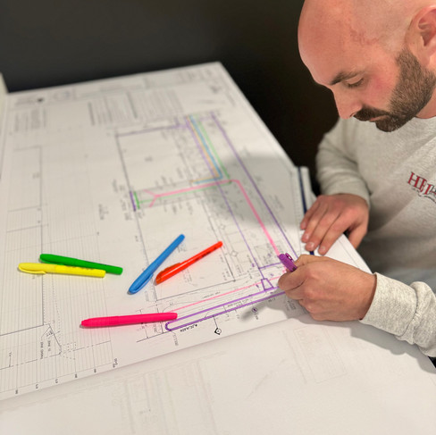 The owner of Hall Builders Inc. looking at plans for a new project