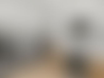 modern-style kitchen design with double-fridgerators, marble countertops, marble backdrop, and wooden cabinetry.