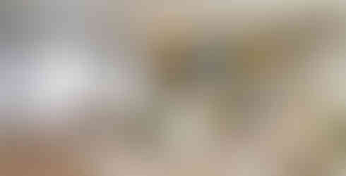 lounge area inside of ADU build with sectional sofa and mounted flat screen TV