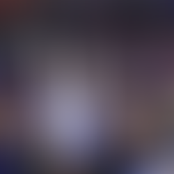 Gymnast Selena Harris-Miranda posing at the end of her routine with her arms in the air.