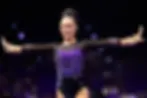 Gymnast Kailin Chio with her arms spread wide during a routine.