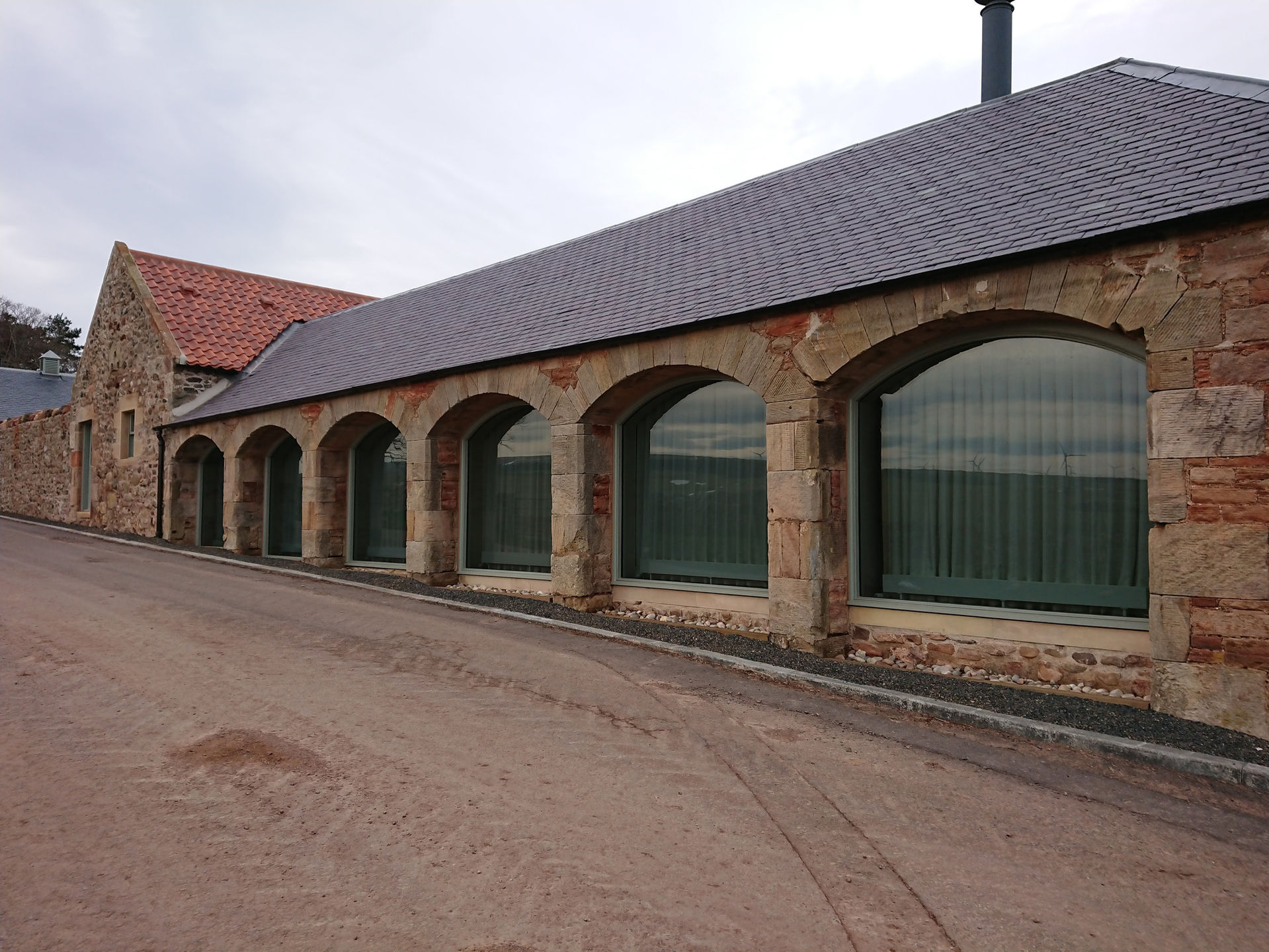 Long stone building with arched windows