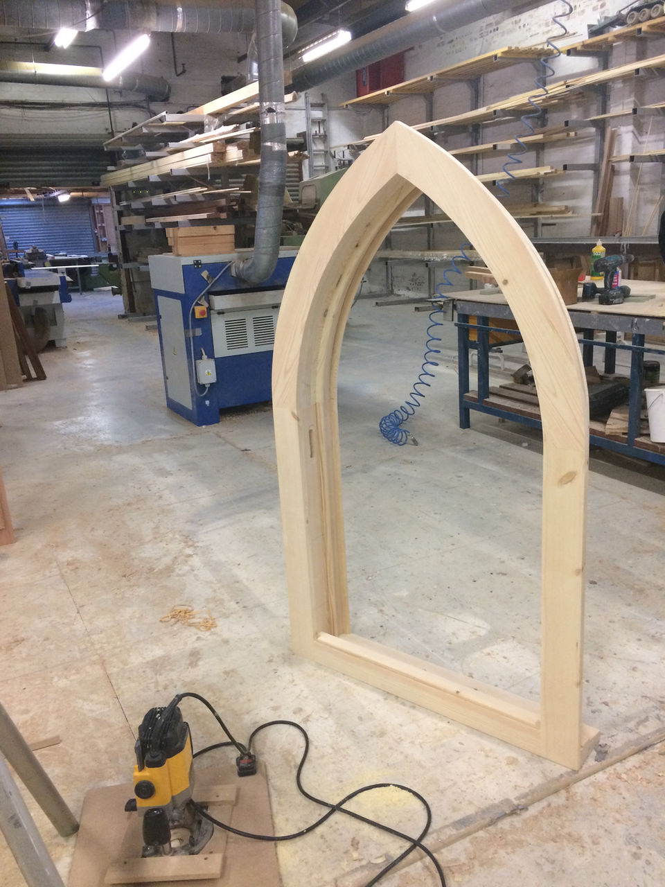 Gothic arch window case wiith workshop in back ground