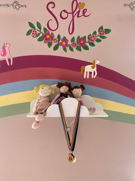 Stunning rainbow mural design across the full room. Fairy holding a wand to create a magical rainbow path for the unicorns to enjoy. Hand-painted by Jennifer Quinn Interiors. Personalised with Sofie's name