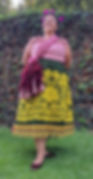 Mexican woman in traditional dress wearing rebozo as sash