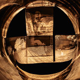 A composition of overlapping negatives arranged in a cross shape within a circular frame. An experimental, warm-toned photograph from 2025, part of the 'Fragments of Life' project, which explores the concepts of time and visual perception.