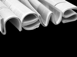 Newspapers folded in the shape of the single word “NEWS,” symbolizing the client’s instinct to report before they reflect.