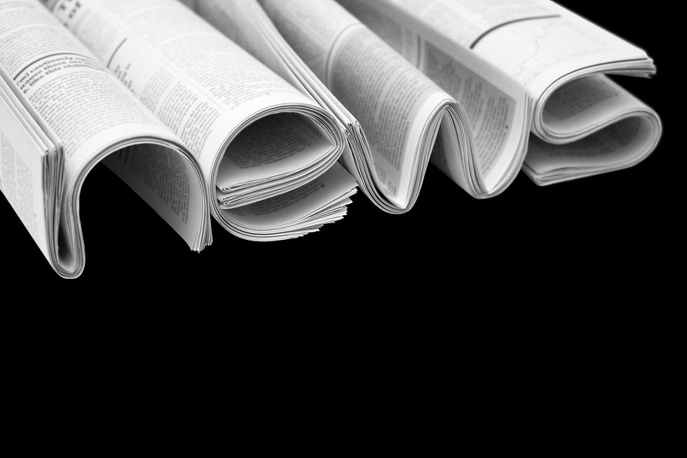 Newspapers folded in the shape of the single word “NEWS,” symbolizing the client’s instinct to report before they reflect.