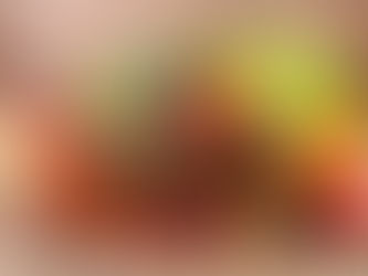 A rustic basket filled with fresh vegetables and ripe fruit, symbolizing the blend of performance coaching (garden) and developmental coaching (orchard).