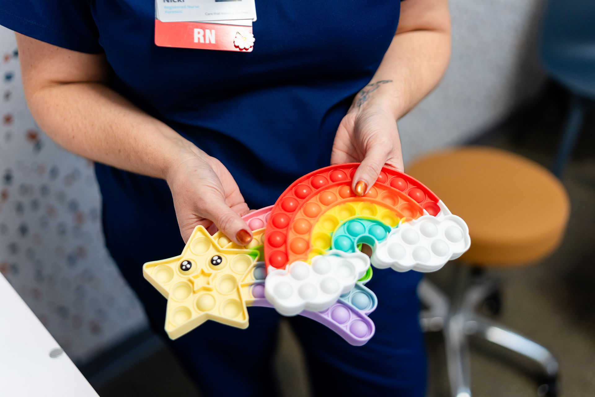 A forensic nurse holds fidget toys in a forensic examination room