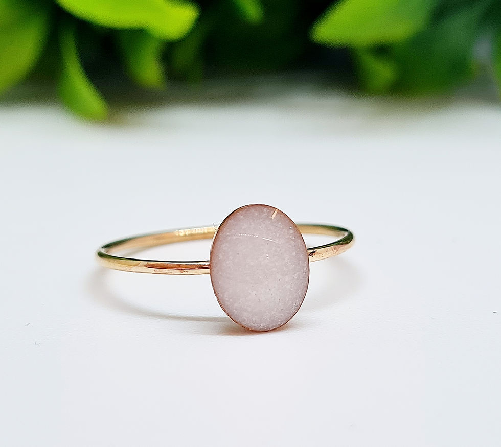 Thumbnail: Oval breastmilk ring with custom resin stone in a minimalist bezel setting