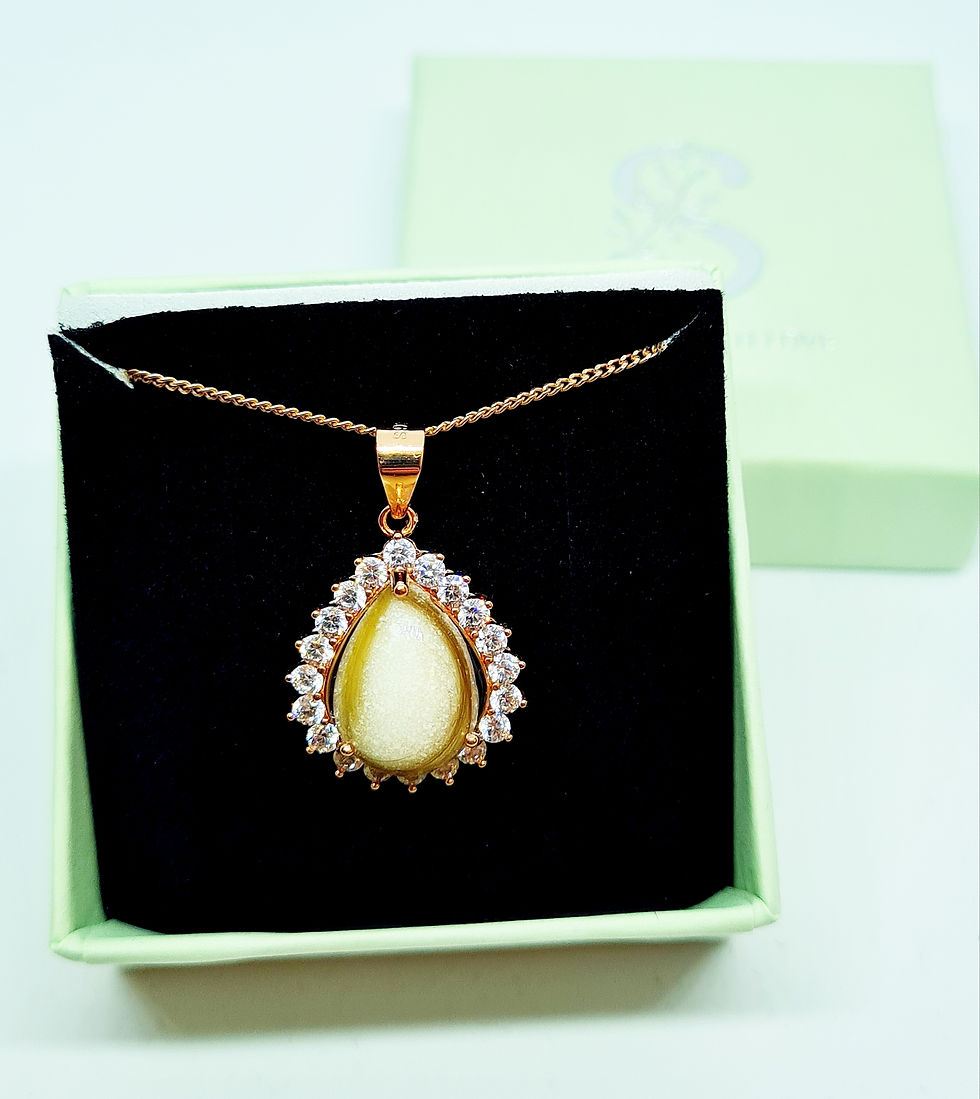 Thumbnail: Teardrop breastmilk necklace with 14x10mm stone and crystal halo setting, shown in rose gold on black display box.