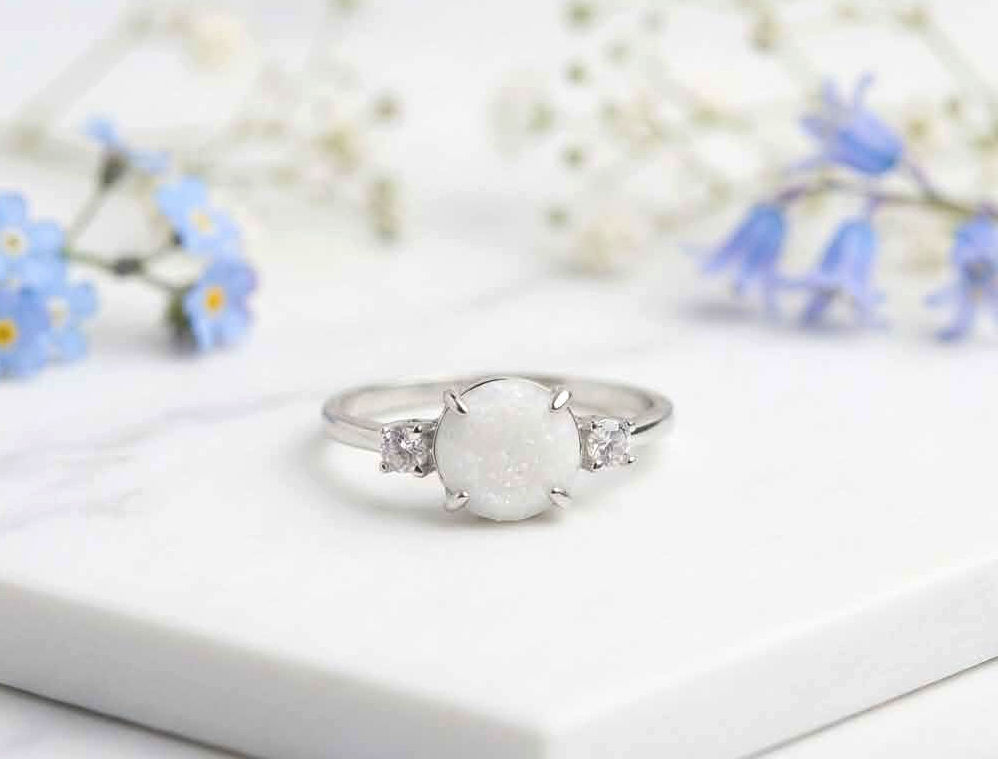 Aria breastmilk memorial ring with 8mm preserved milk stone and crystal side accents in sterling silver band