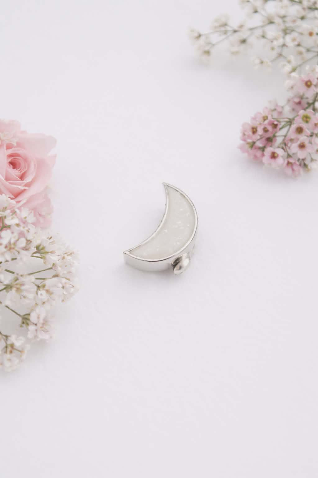 Crescent moon keepsake charm with preserved breastmilk set in sterling silver