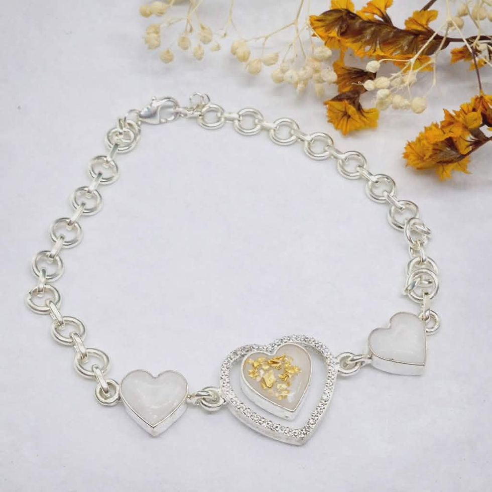 Calia bracelet with three heart bezels filled with inclusions, shown in silver and gold options