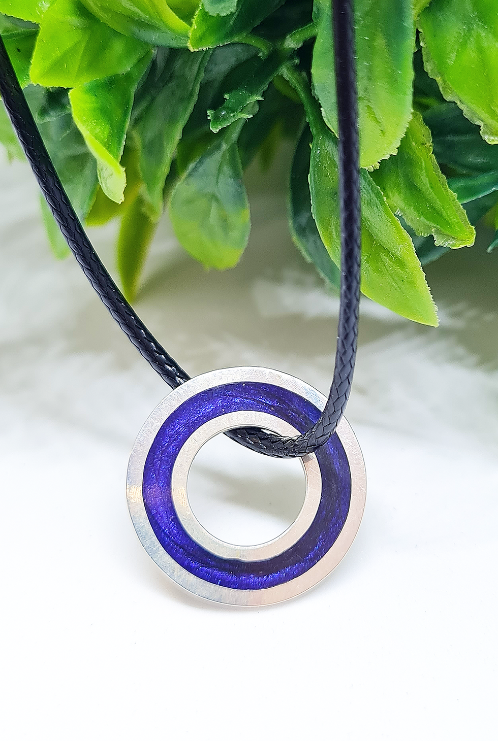 Thumbnail: Washer necklace displayed with greenery on leather cord