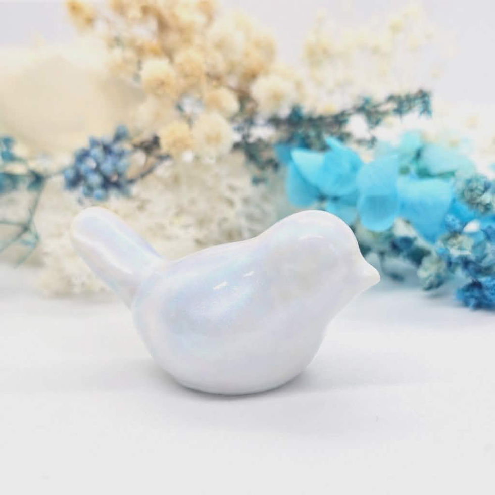 White breastmilk bird sculpture with smooth finish, 46mm keepsake displayed on white surface with soft florals.