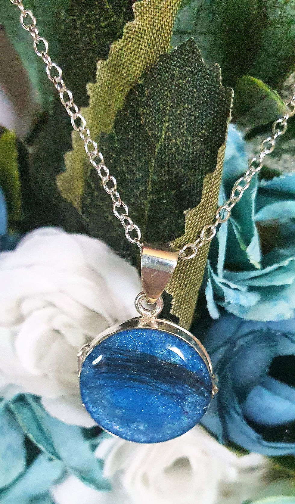 Thumbnail: Memorial ashes locket in sterling silver with circular inclusion front and matching chain, styled on neutral background.