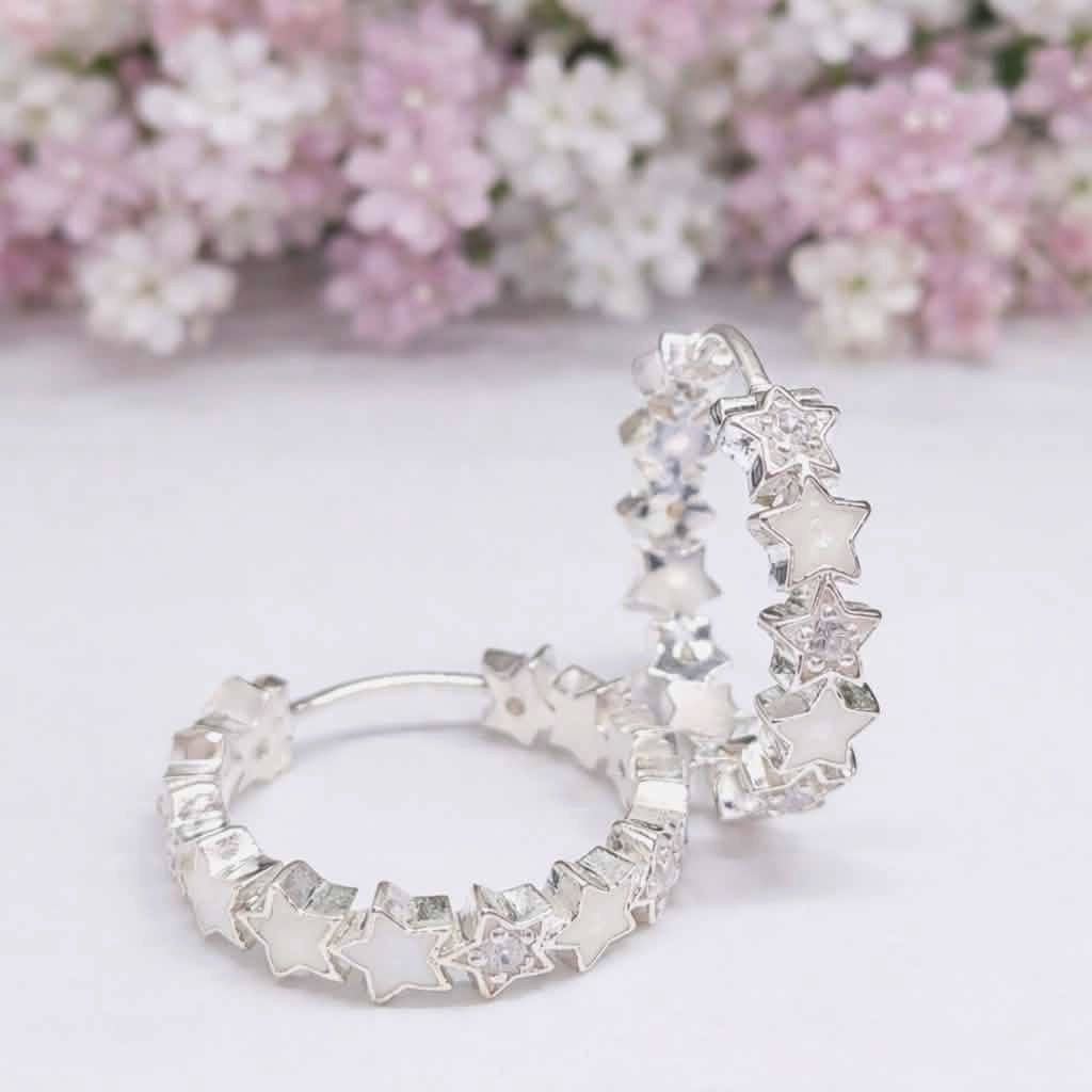 20mm star hoop earrings with alternating breastmilk resin and diamanté birthstone stars, shown in sterling silver.