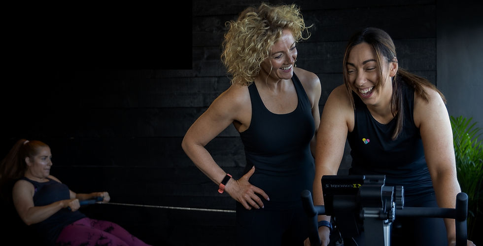 Two women laughing during a strength session at ZoMe in Blessington, Co. Wicklow