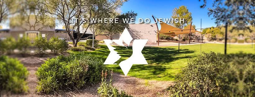 Wide landscape photo of the synagogue courtyard lawn with trees, shade sails, and the text 'IT'S WHERE WE DO JEWISH'