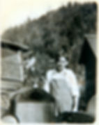 Edward Callahan in overalls stands by his first car with a mountainous backdrop of Shoup behind him.