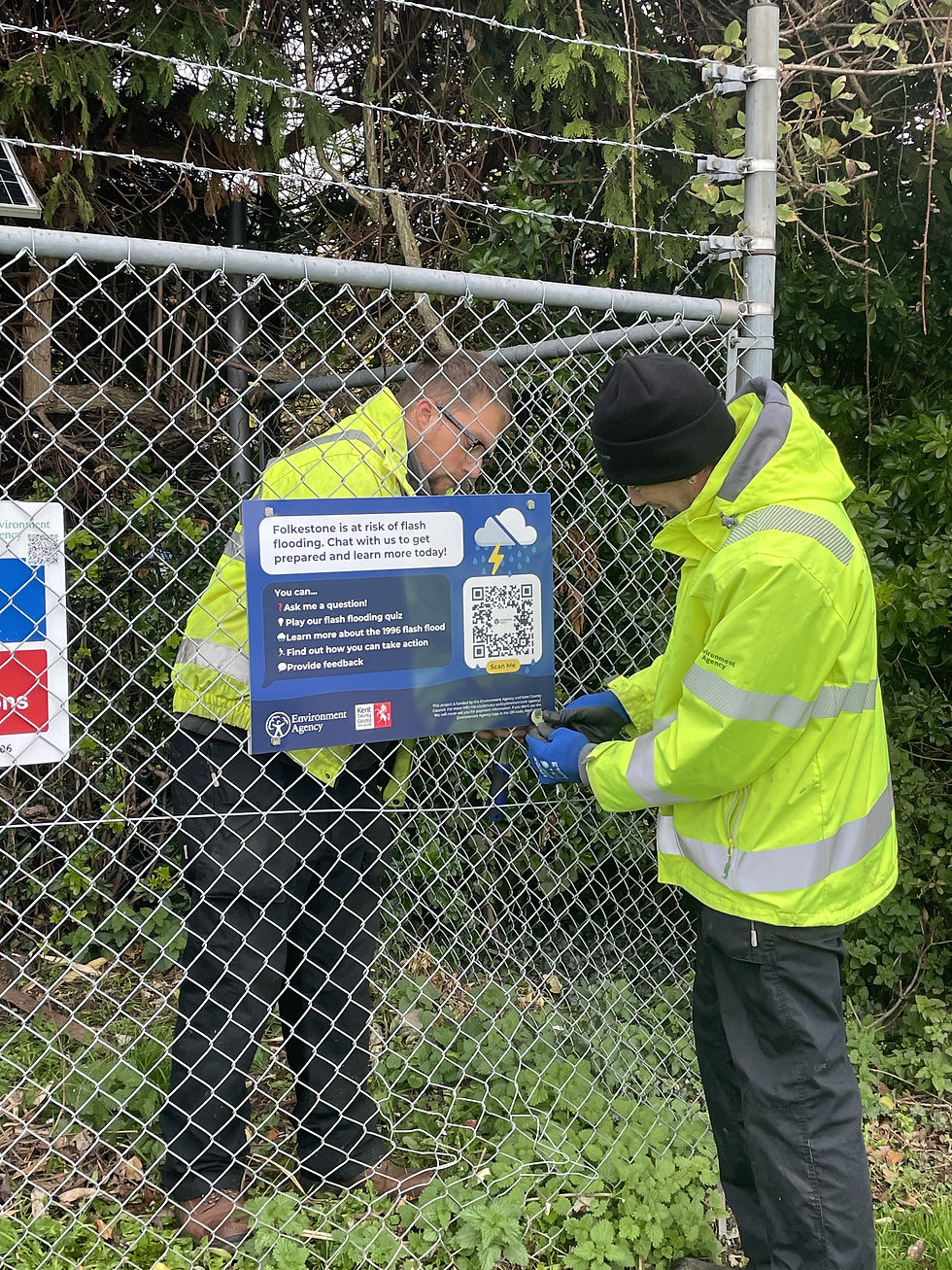 Installing the signs at Morehall recreation ground. Photo credit: Environment Agency