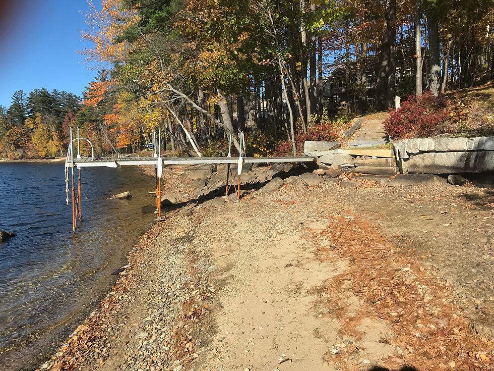 Eye-level view of a small dock sitting above lowered fall lake water.