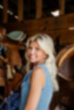 Proffessional Photoshoot Portrait of blonde woman standing in a wood tack room