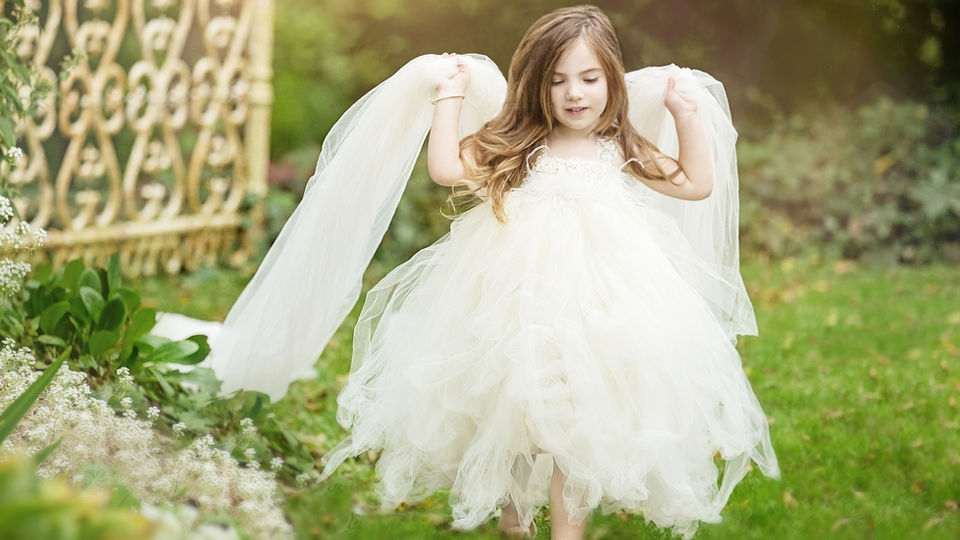 A girl running in the gardens in her child portrait at Chalet Studio